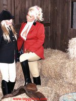 Two stunning girls dressed as jockey enjoy some real leasbian action in the stables