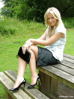 Hot blonde Milf Jess shows her shiny black heels and stockings in her cheeky short office skirt
