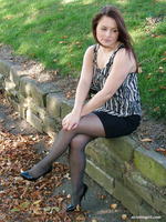 Hot brunette Sara is posing outdoors in her silky black nylons and tall shiny heels