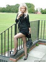 Beautiful blonde dressed in black and showing off her high heels