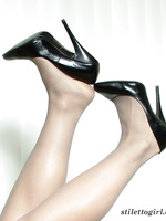 Classy blonde wearing black high heel stilettos and sexy stockings