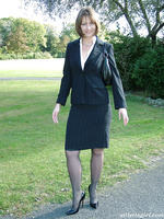 Cute brunette outdoors wearing stockings and black high heels