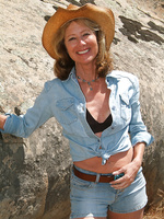 61 year old Janet L peels of her blue jeans and spreads on the rocks