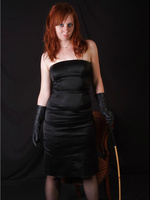 Sexy red head wearing some saucy leather gloves