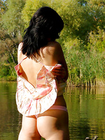 Alluring holly stripping all her clothes till gets totally naked in the lake