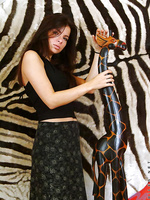 A very naked danica stands next to a wooden giraffe wtf yeah exactly