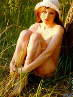 Charming honey girl with tasty body goes totally naked on a tree trunk