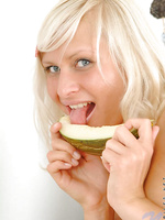 Look at this hottie she is blonde and cute and has big tits and oh yea she is eating a slice of melon
