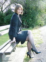 Cute brunette outdoors wearing stockings and black high heels