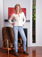 Blonde MILF Liz slips off her tight denim jeans and poses
