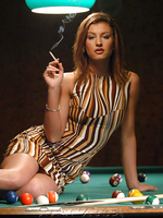 Beautiful sexy smoking girl on the pool table