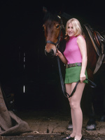 Blonde enjoying riding her big horse outdoor