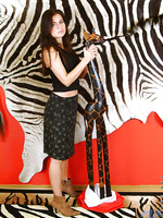 A very naked danica stands next to a wooden giraffe wtf yeah exactly
